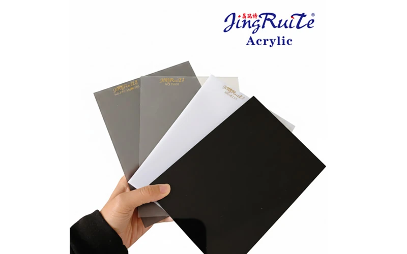 Hand holding JingRuiTe acrylic sheet samples for commercial signage material selection