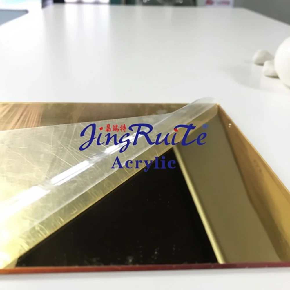 Peeling PE protective film off a gold PMMA mirror acrylic sheet showing clean reflective surface