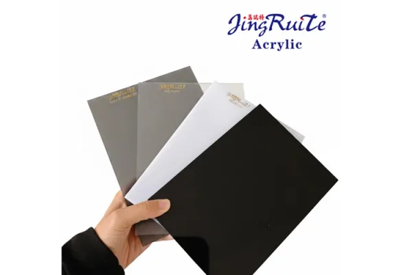 Hand holding JingRuiTe acrylic sheet samples for commercial signage material selection